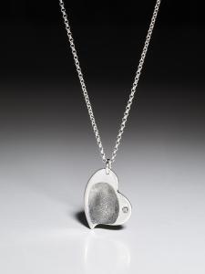 Silver necklace with a curved fingerprint heart pendant in fine silver
