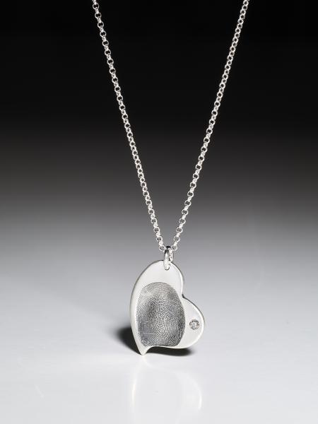 Silver necklace with a curved fingerprint heart pendant in fine silver