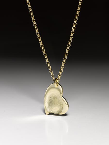 Silver necklace with a curved fingerprint heart pendant in fine silver